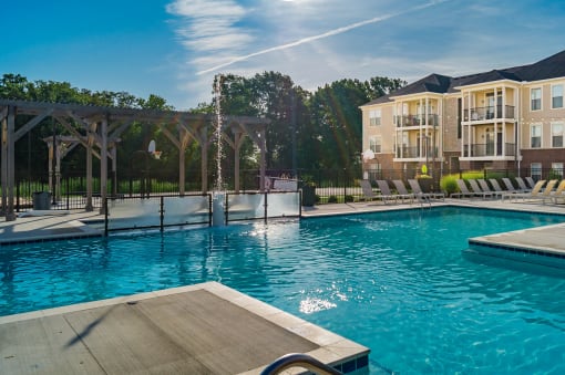 pool with apartment building in the back at The Greyson, Hilliard