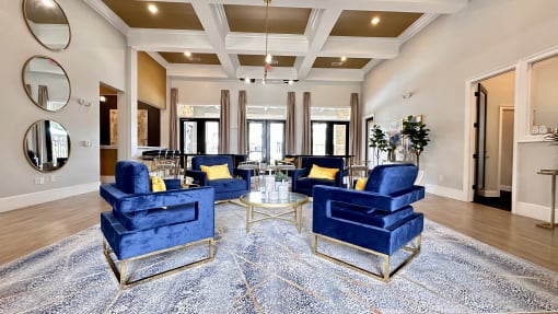 a living room with blue chairs and a rug at Waterstone at Cinco Ranch, Katy, TX, 77450