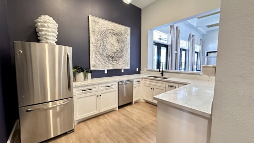 a kitchen with white cabinets and a stainless steel refrigerator at Waterstone at Cinco Ranch, Katy, TX, 77450
