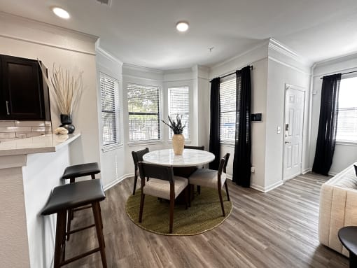 a kitchen and dining room with a table and chairs at Grand Villas Apartments, Katy