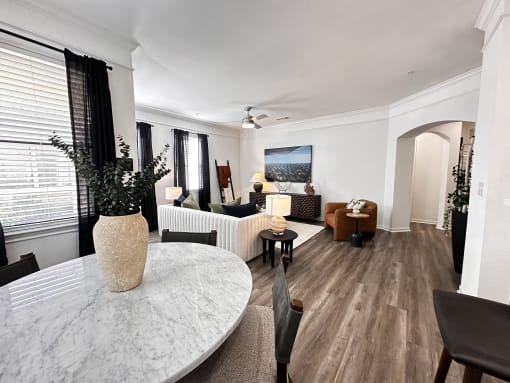 a living room and dining room with a marble table at Grand Villas Apartments, Katy