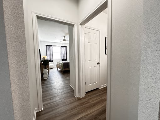 a view of the living room from the hallway with the bedroom door open at Grand Villas Apartments, Katy