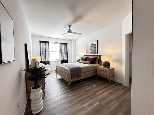 a bedroom with a bed and a ceiling fan at Grand Villas Apartments, Katy