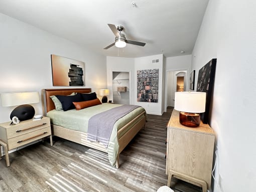 a bedroom with a bed and a ceiling fan at Grand Villas Apartments, Katy