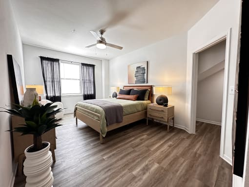 a bedroom with a bed and a ceiling fan at Grand Villas Apartments, Katy
