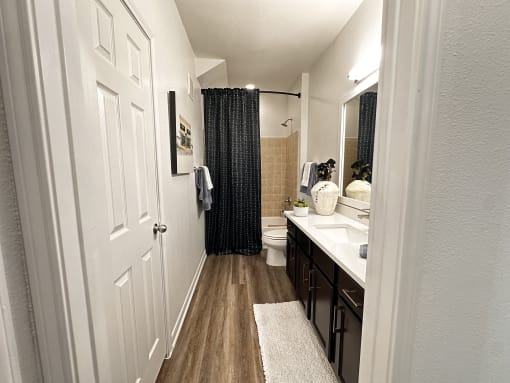 a bathroom with a shower and a sink and a toilet at Grand Villas Apartments, Katy