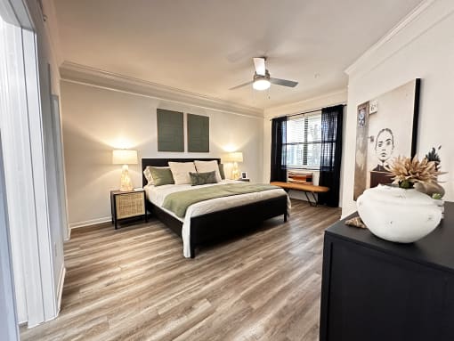a bedroom with a bed and a ceiling fan at Grand Villas Apartments, Katy