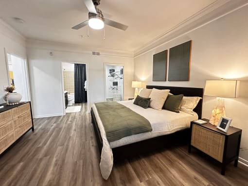 a bedroom with a bed and a ceiling fan at Grand Villas Apartments, Katy