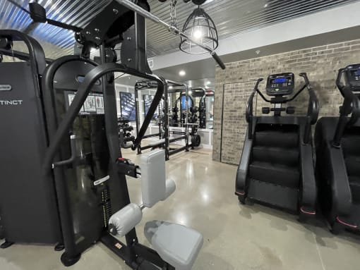 a gym with cardio equipment and a treadmill