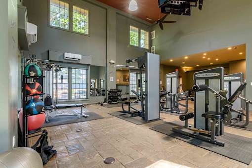 Spacious fitness center with strength training equipment at London House Apartments, Kansas