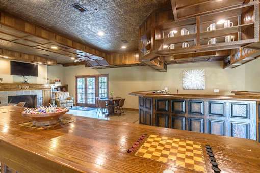 Clubhouse recreation room with bar and game tables at London House Apartments, Kansas, 66215