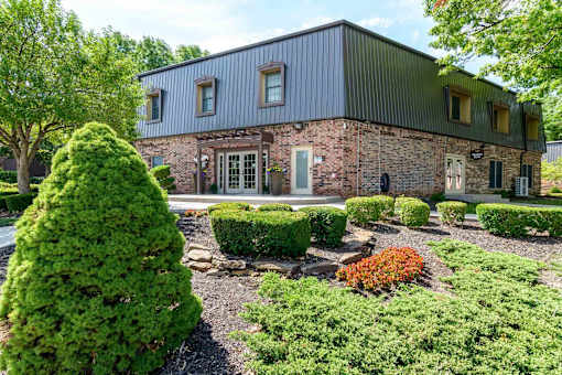 Commercial building exterior with manicured landscaping at London House Apartments, Lenexa, 66215