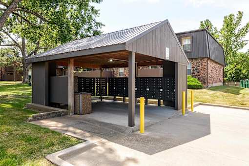 Covered mailbox area with package lockers at London House Apartments, Lenexa, Kansas