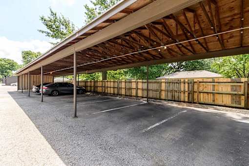 Covered parking carport with assigned spaces at London House Apartments, Lenexa