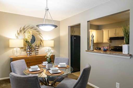 Dining area with kitchen pass through window at London House Apartments, Lenexa, KS 66215