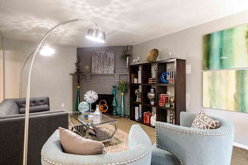 Modern living room with decorative shelving and seating at London House Apartments, Lenexa, KS