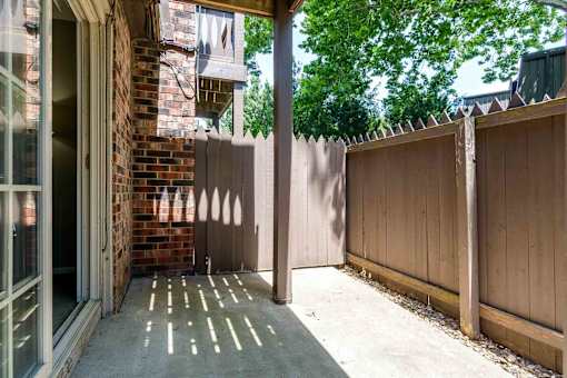 Private patio with wood privacy fence at London House Apartments, Lenexa, 66215