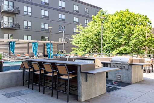 A bar with stools is set up on a patio.