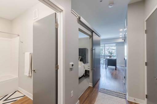 A modern kitchen with a white fridge and a white door.
