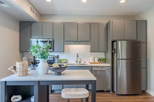 A modern kitchen with a table and chairs.