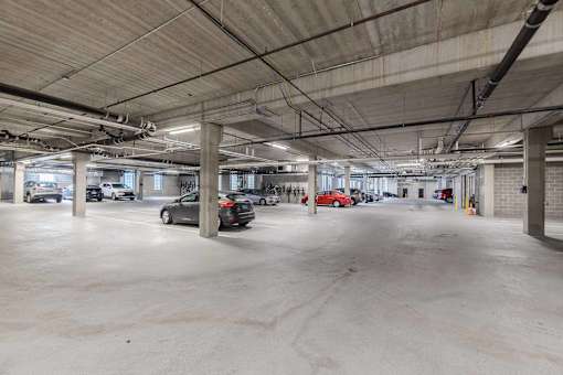 A large, empty parking garage with concrete floors and walls.