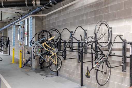 A bike rack with several bicycles parked on it.