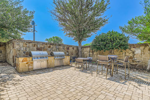 the backyard has a picnic table and barbecue grill at Discovery at Craig Ranch, McKinney, TX