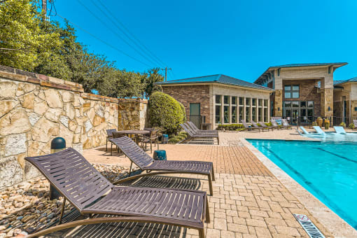 a swimming pool with chaise lounge chairs and a poolside building with a pool at Discovery at Craig Ranch, McKinney, TX, 75070