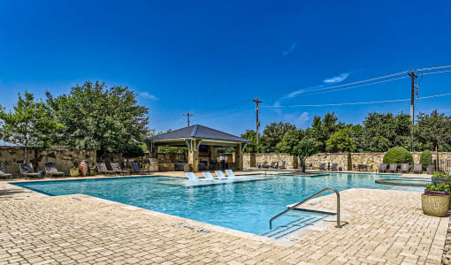 a swimming pool with a gazebo and chairs around it at Discovery at Craig Ranch, McKinney, Texas