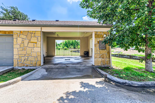 the front entrance of a house with a driveway and tree at Discovery at Craig Ranch, Texas, 75070