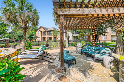 a patio with lounge chairs and a pergola at River Pointe, Conroe, TX, 77304