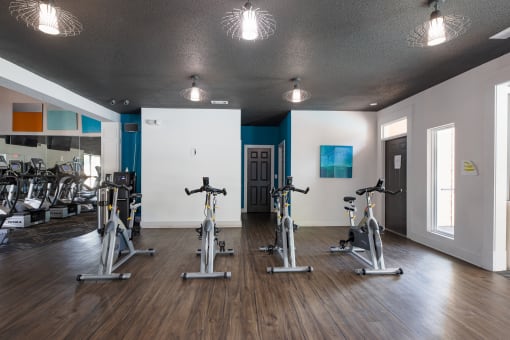 a gym with treadmills and other exercise equipment on a wooden floor  at Butternut Ridge, North Olmsted, 44070