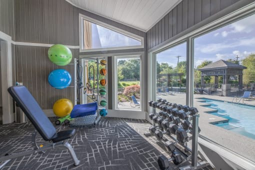 a home gym with a view of a swimming pool and glass doors  at Butternut Ridge, Ohio, 44070