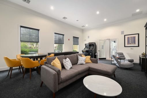 a living room with a couch and a table with chairs at Sovereign at Overland Park, Overland Park Kansas