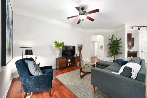 a living room with two couches and a ceiling fan at Sovereign at Overland Park, Kansas