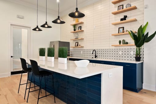 a blue and white kitchen with a white counter top at Sovereign at Overland Park, Kansas