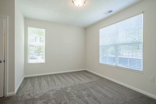 A room with a carpeted floor and a window with blinds. at Overland Park, Pickerington