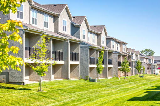 back exterior of townhomes with lawn at Prairie Pines Townhomes, Kansas