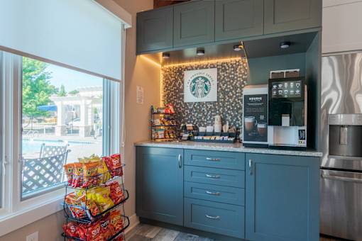 A kitchen with a Starbucks sign on the wall.