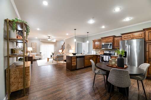 A modern kitchen with a dining table and chairs.