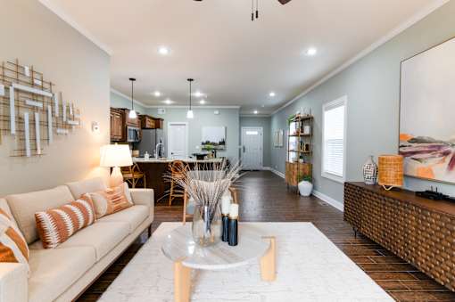 A modern living room with a white sofa and a coffee table.