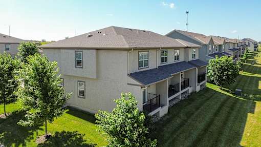 A large house with a lawn in front.