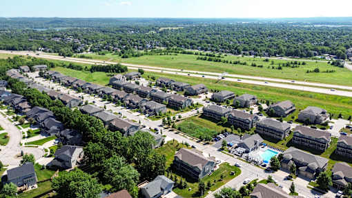A bird's eye view of a residential area with houses and a swimming pool.