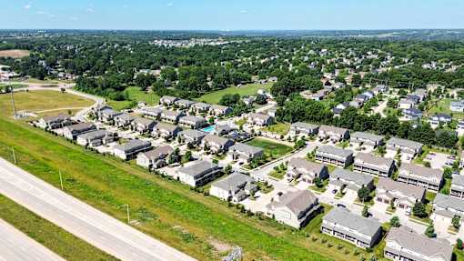A bird's eye view of a residential area with houses and greenery.