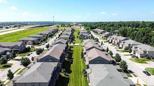 A suburban neighborhood with rows of houses and a clear sky.