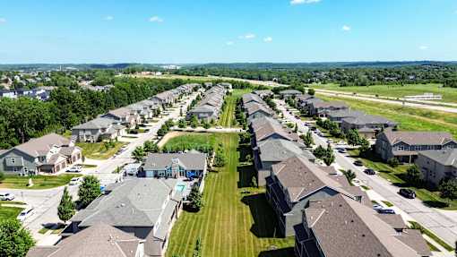 A suburban neighborhood with houses and green lawns.