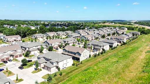 A suburban neighborhood with houses and green lawns.