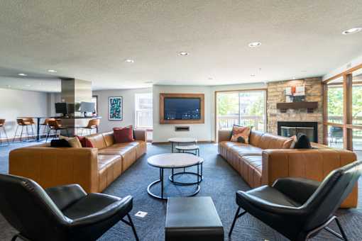 A living room with a fireplace and a flat screen TV.