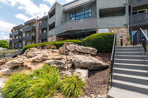 A modern building with a rocky outcrop in front.