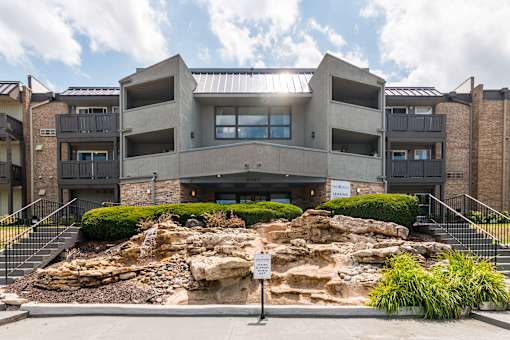 A modern building with a rocky outcrop in front.